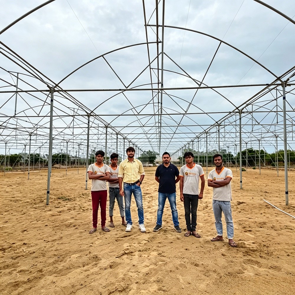 Installation team inside a completed greenhouse frame