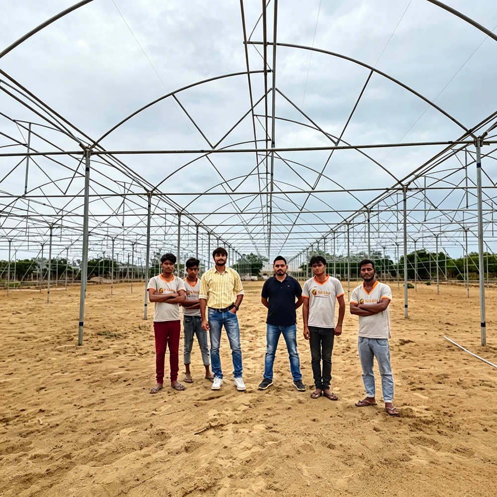 Greenhouse frame installation team on a project site