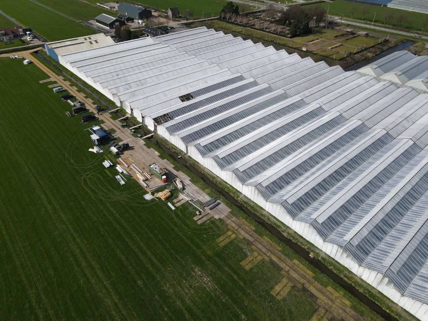 aerial view of commercial glass greenhouse block