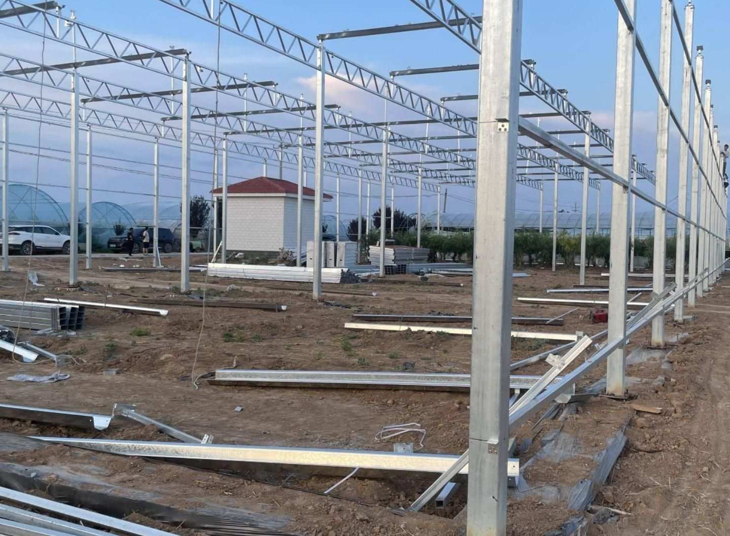 glass greenhouse steel frame under assembly on site