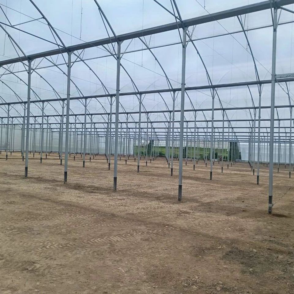 Empty frame of a film covered greenhouse waiting for planting