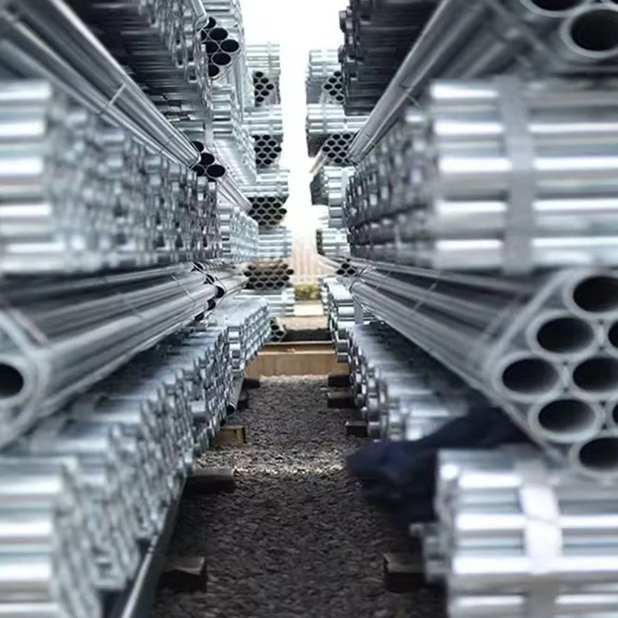 Galvanized pipes stored in long stacks at an outdoor yard