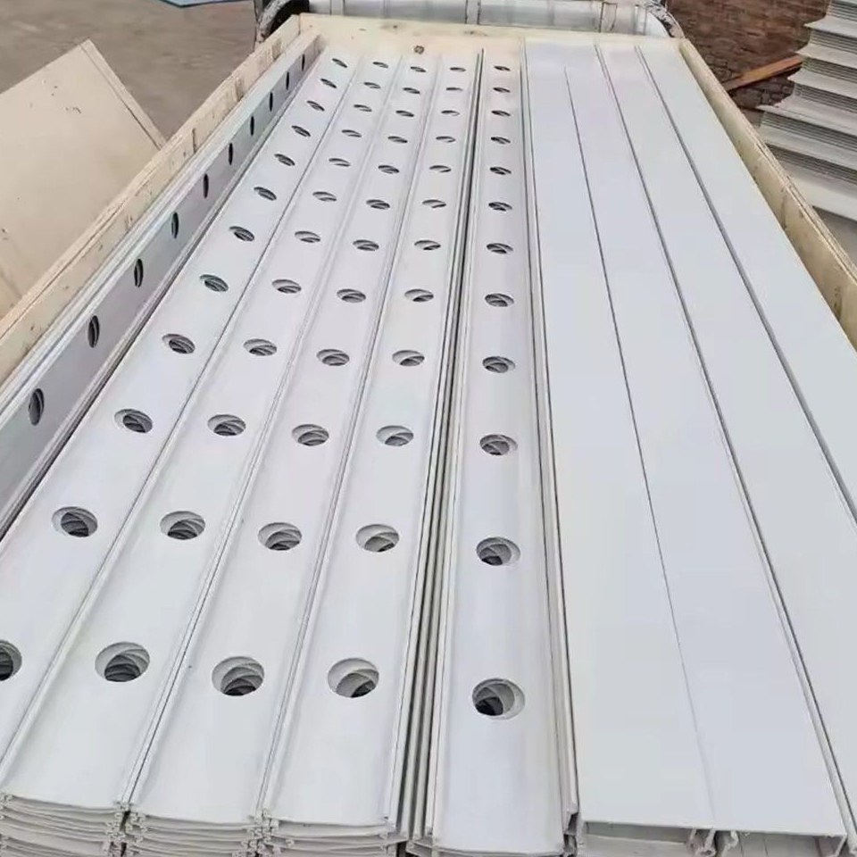 Stacked white NFT hydroponic channels waiting for installation
