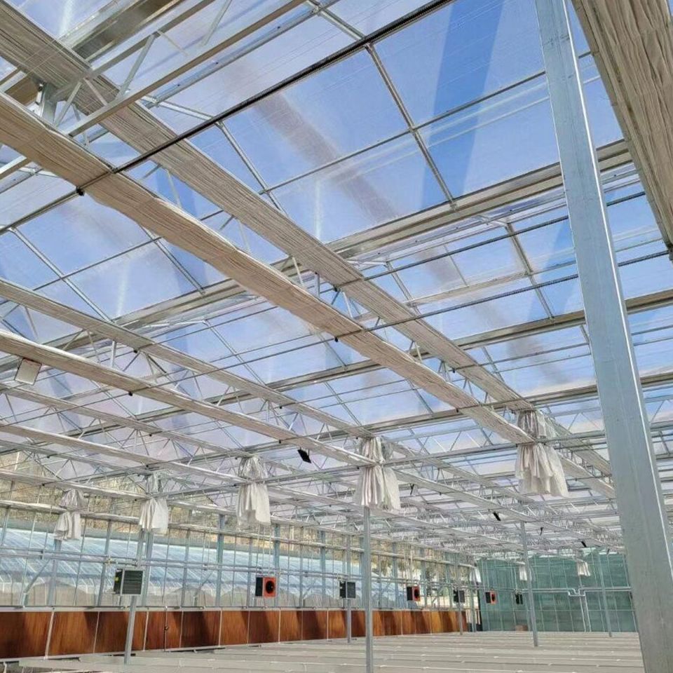 Empty insulated panel greenhouse with roof vents and long benches