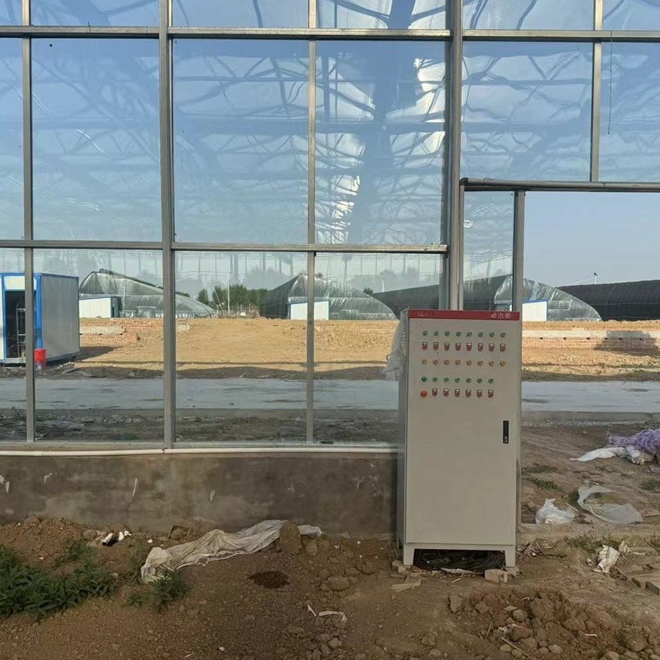 Control cabinet at the wall of a polycarbonate greenhouse