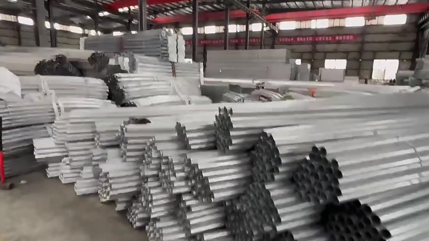 Stacks of galvanized greenhouse pipe and fittings in a warehouse ready for shipment
