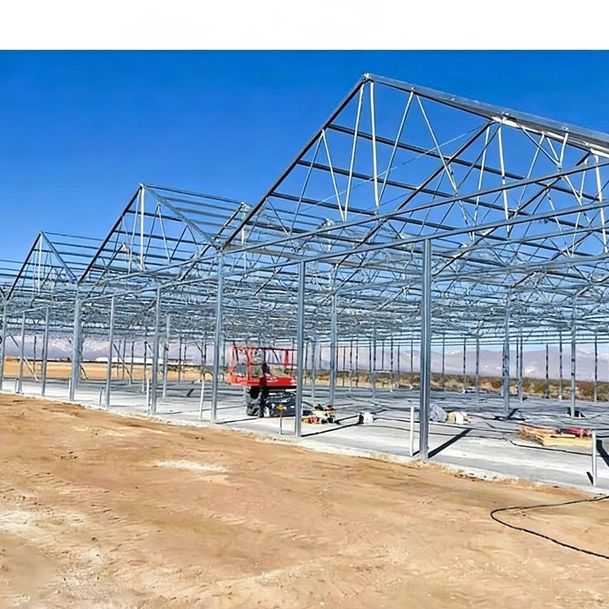 Bare galvanized steel frame of a multi span greenhouse under construction