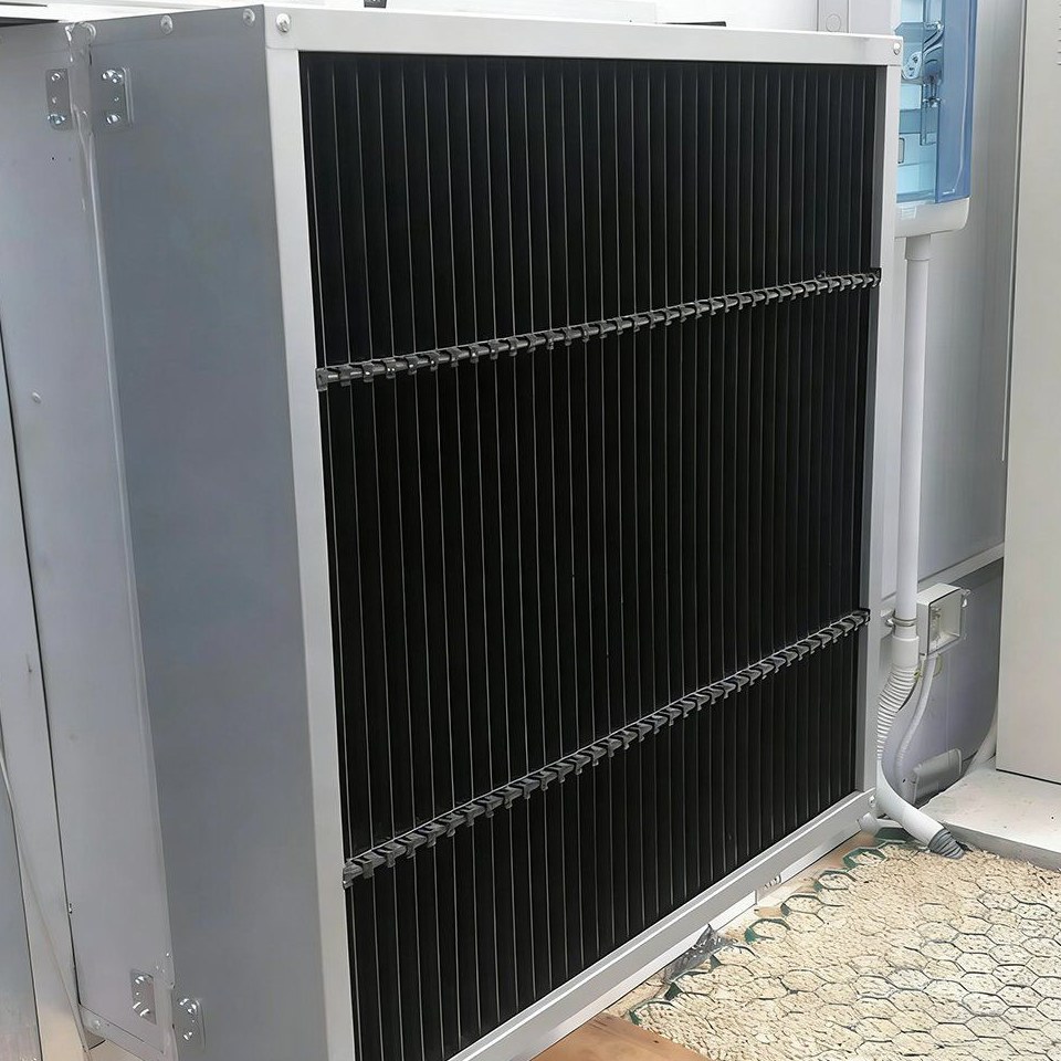 Exhaust fan unit beside a cooling pad inside a film tunnel greenhouse
