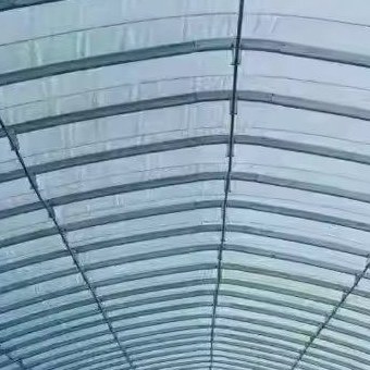 Film covered tunnel greenhouse standing in an open field