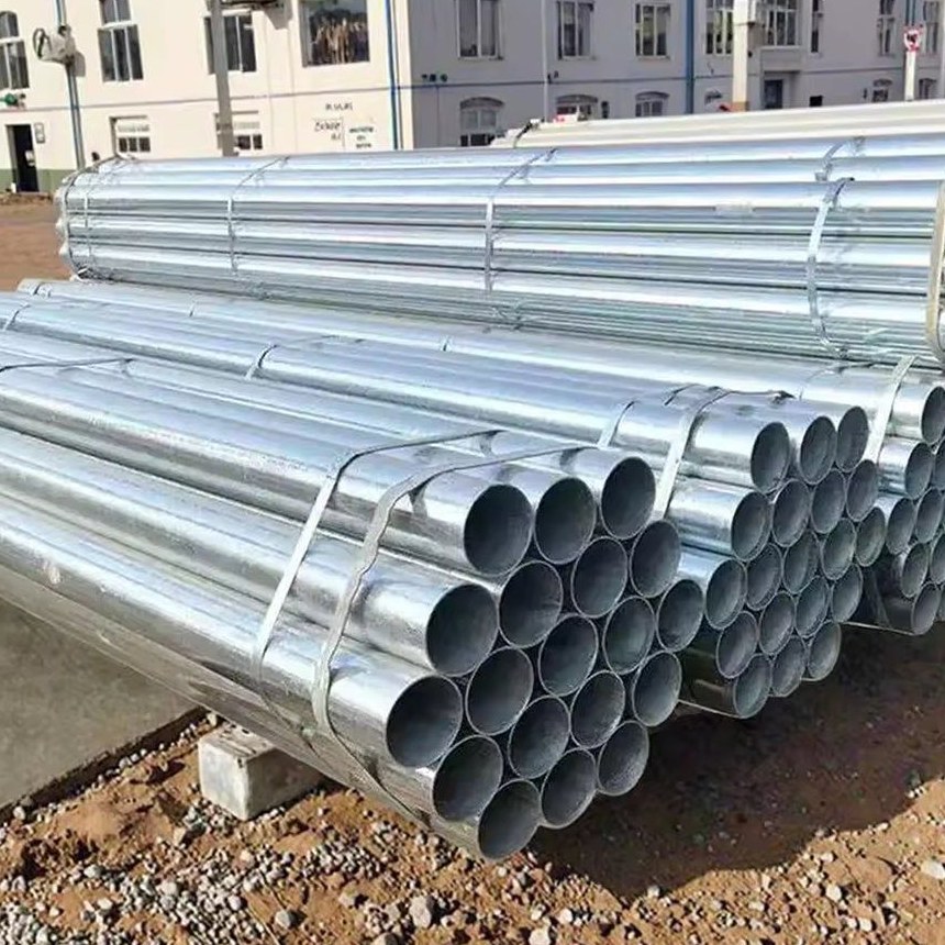 Long square galvanized pipe stacks stored at an outdoor yard