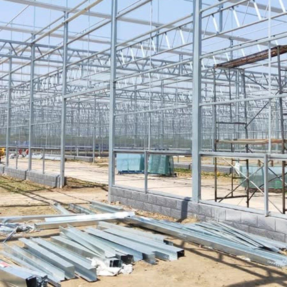 Steel frame and glazing under construction on a prepared site