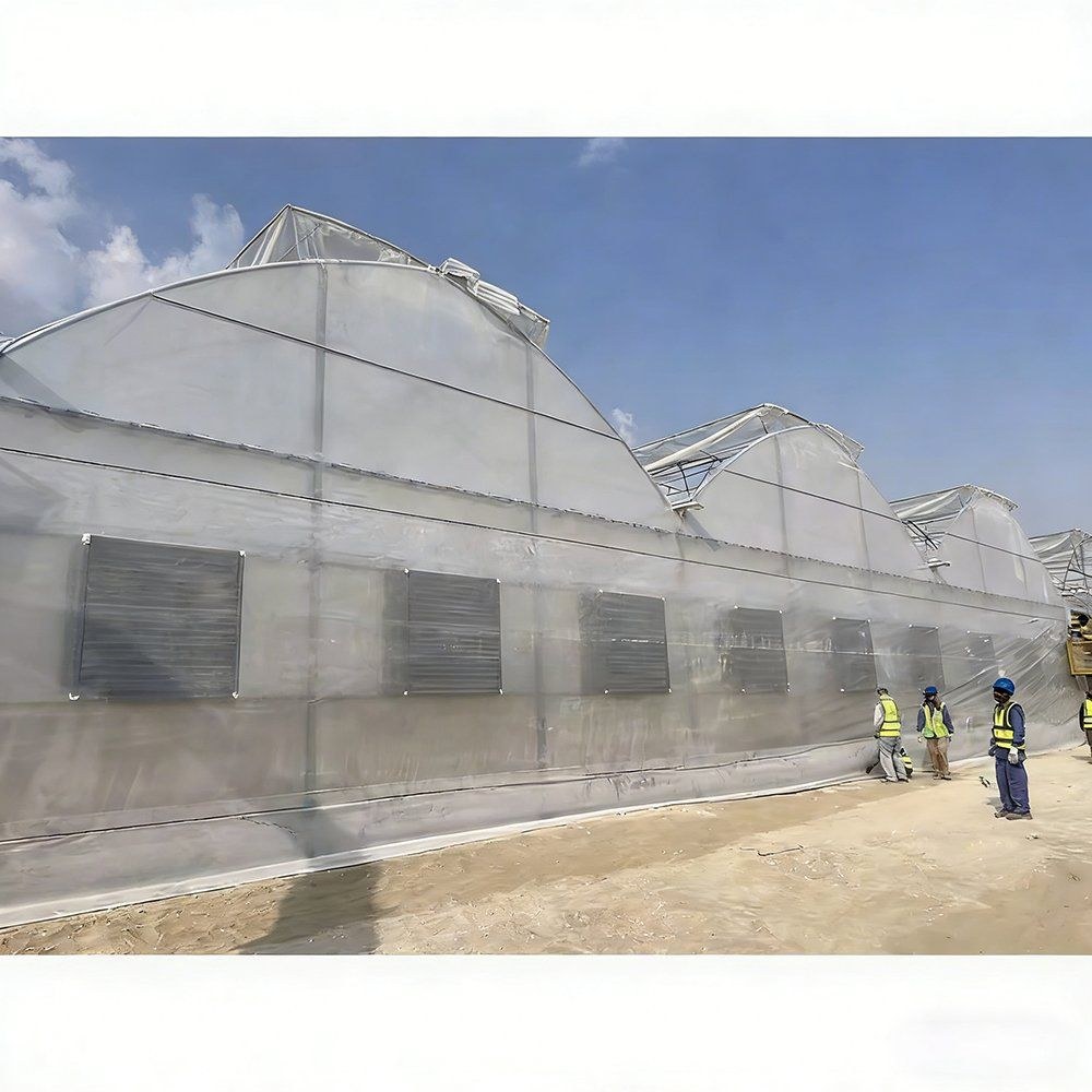 Gothic arch film greenhouse with louvre vents along the side wall