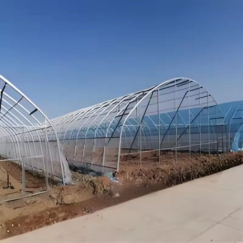 Bare frame of an arched film greenhouse under construction