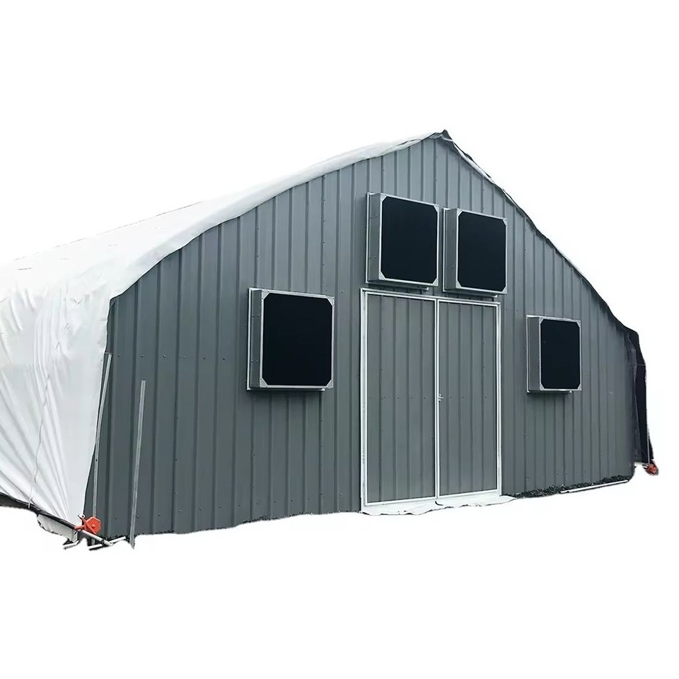 Greenhouse gable end clad in grey panels with black louvre openings and a door
