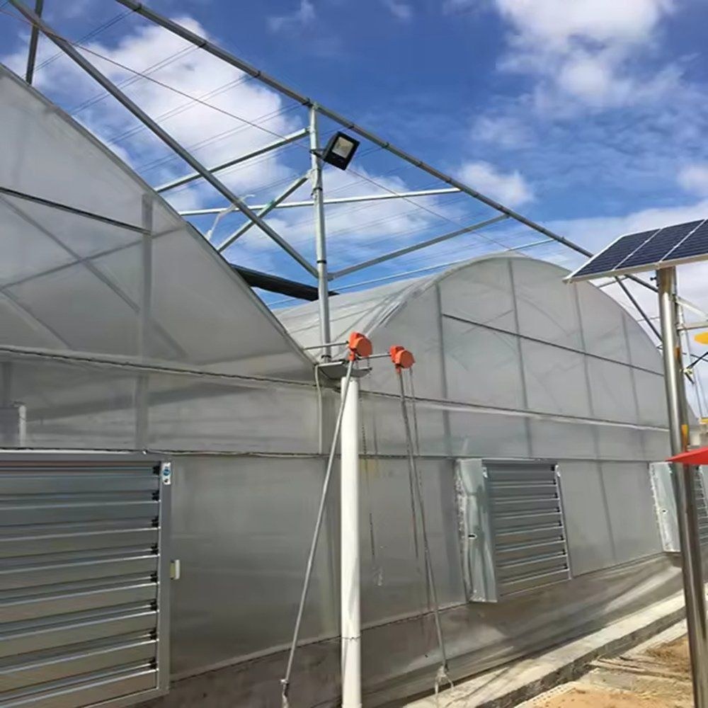 Close view of the polycarbonate wall panel, louvre vent and a solar panel on a post