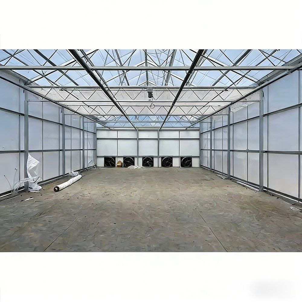 Interior of the greenhouse with a concrete floor and PC sheet walls