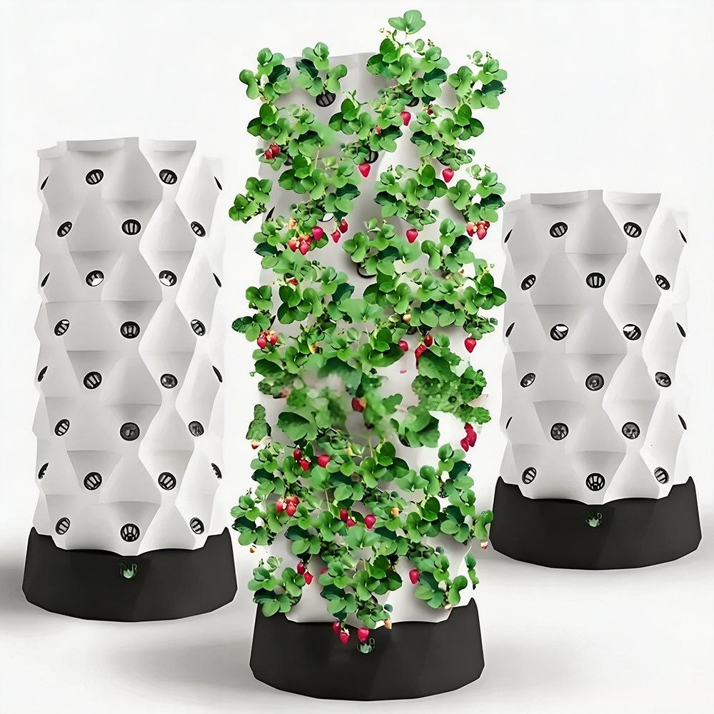 Three hydroponic growing towers with one carrying strawberry plants