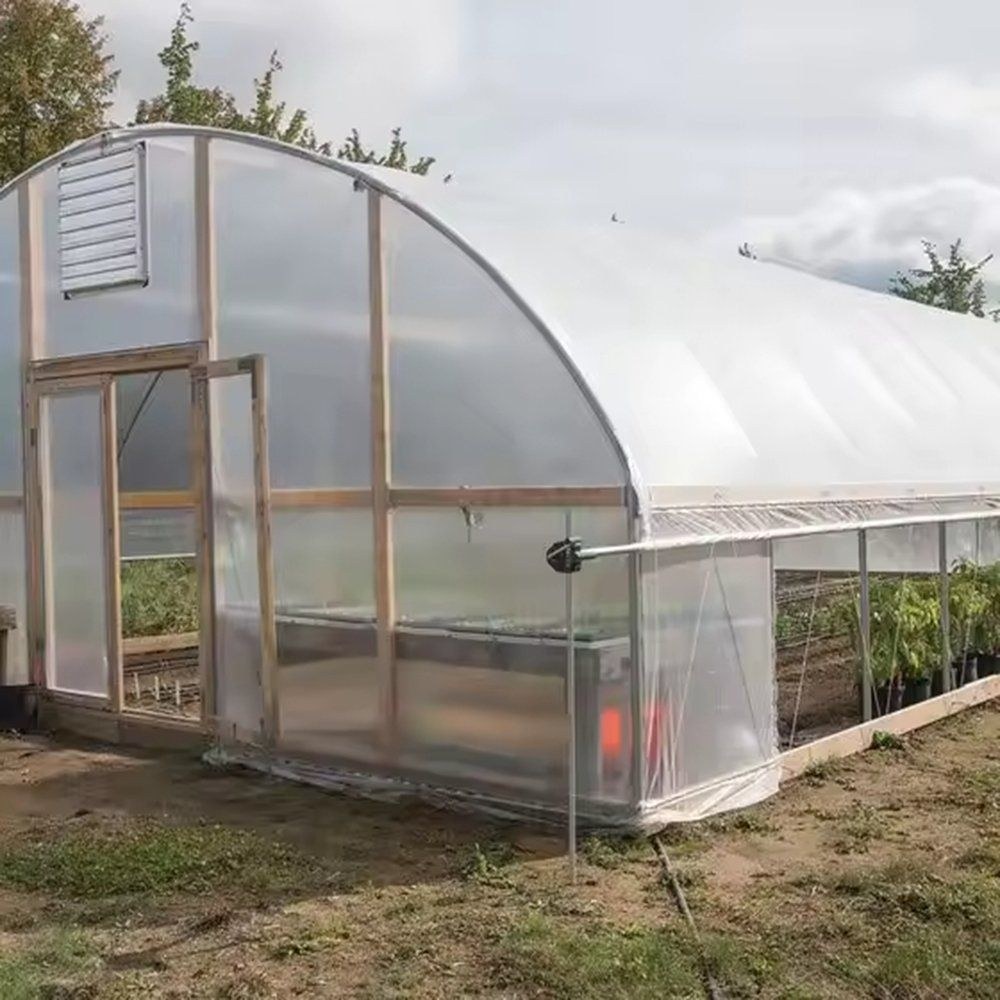 End wall and doorway of a gothic arch greenhouse with a rolled side vent