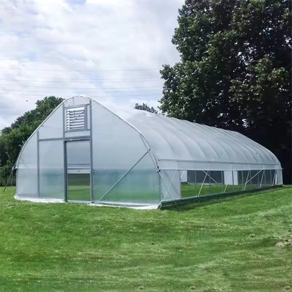 Completed gothic arch tunnel greenhouse standing on a lawn