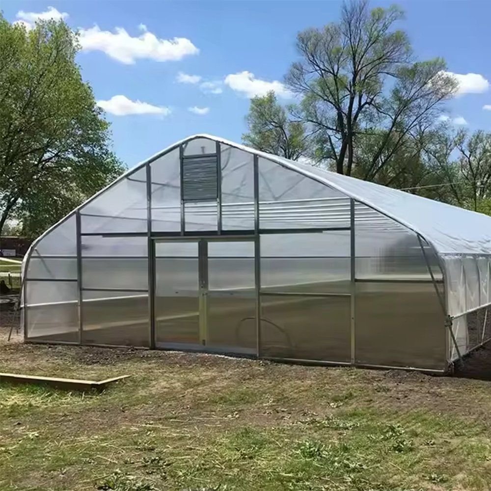 Single span gothic tunnel greenhouse with a framed door and film cover