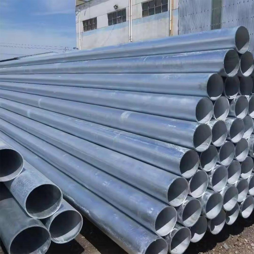 Bundles of galvanized steel pipe beside a building