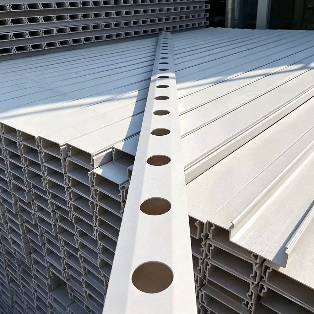 Close view of a white NFT channel showing the planting openings and feed line