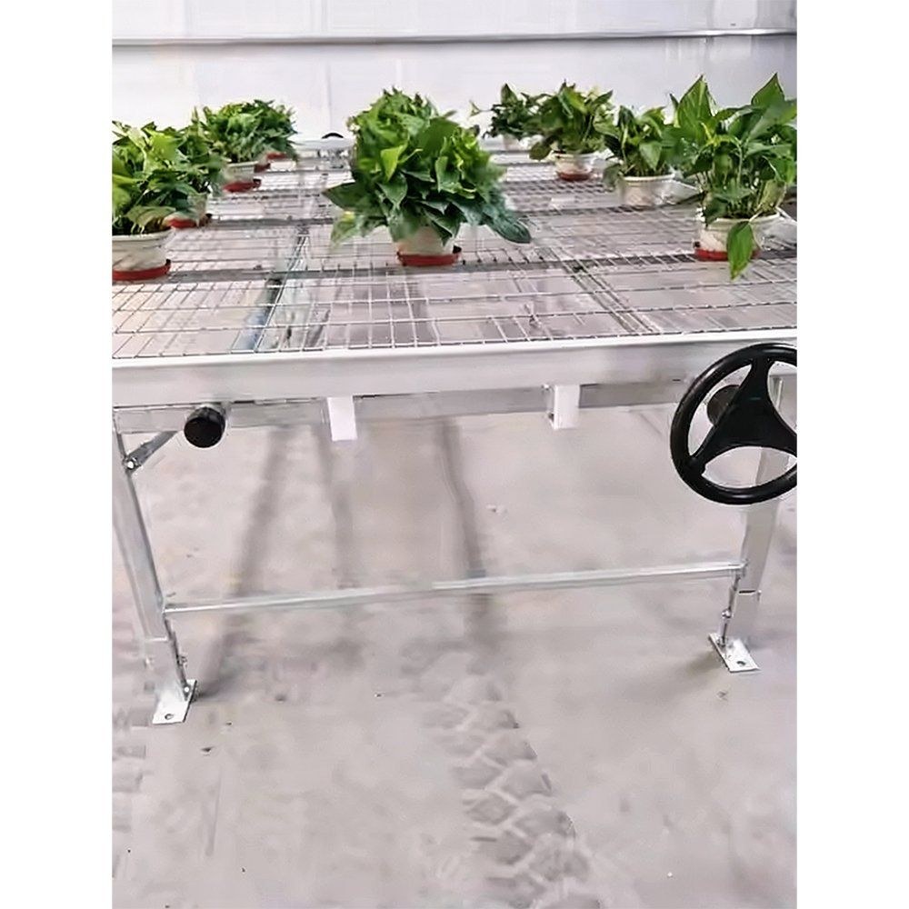 Nursery bench with a handwheel drive and potted plants in a bay