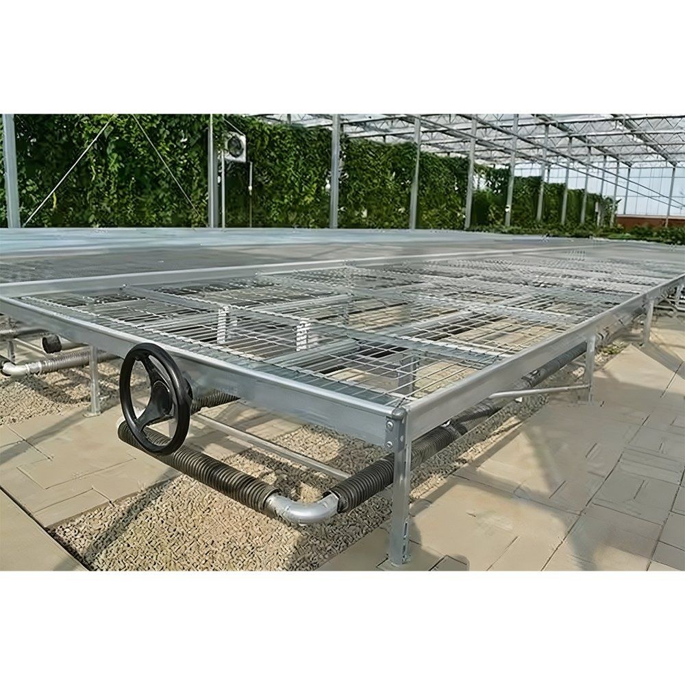 Empty nursery benches under a shade screen in a greenhouse