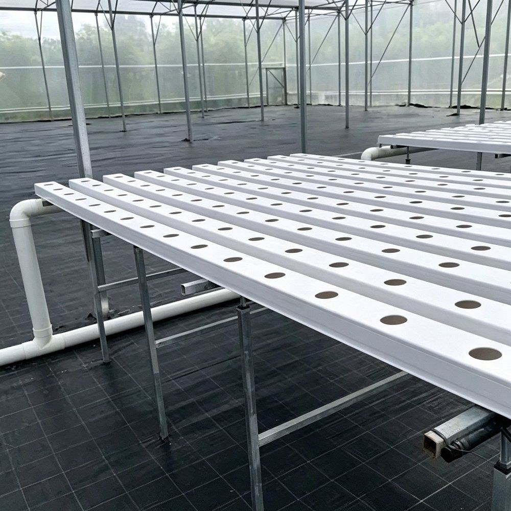 Empty white hydroponic channel frame in a greenhouse before planting