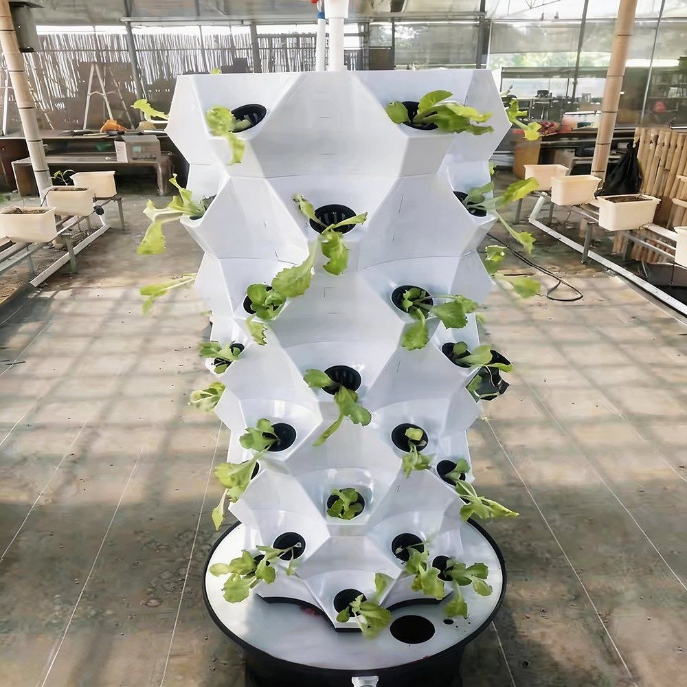 Empty white plant tower standing in a greenhouse before planting