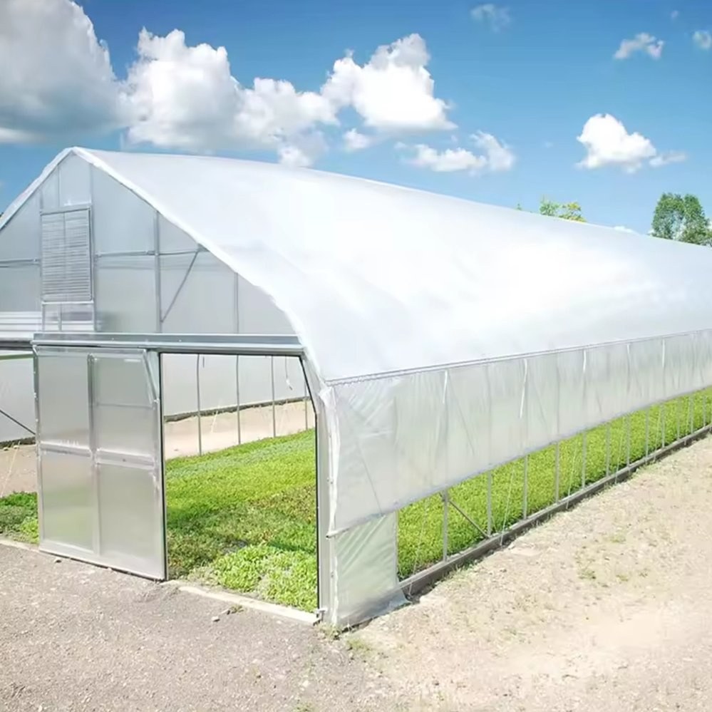 Single span arched greenhouse structure with a film cover and open doors