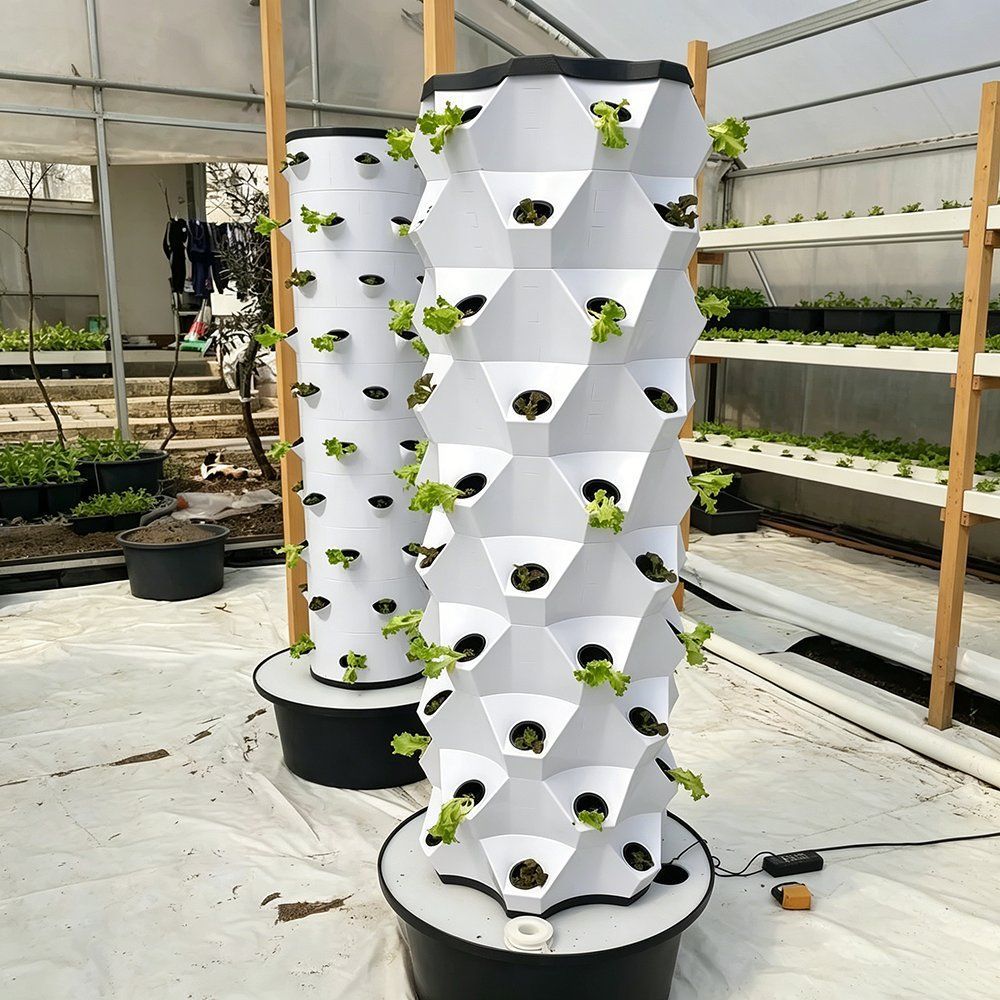 Hydroponic tower columns standing in a greenhouse growing bay