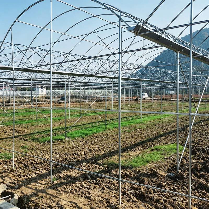 Single span tunnel arches erected across an open field