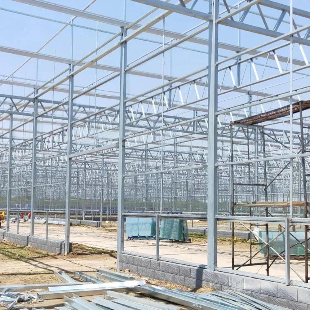 Bare galvanized frame of a multi span greenhouse under open sky