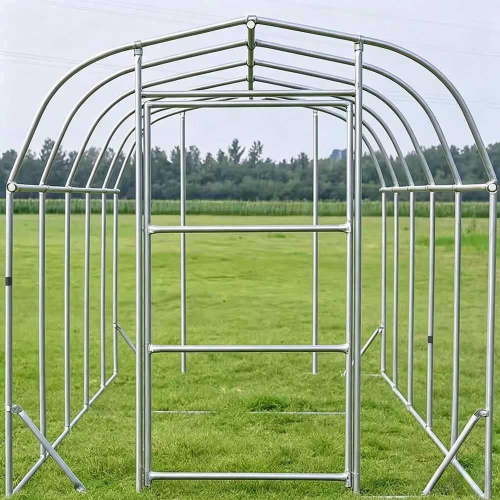 Bare galvanized arch frame of a walk in tunnel greenhouse on a lawn